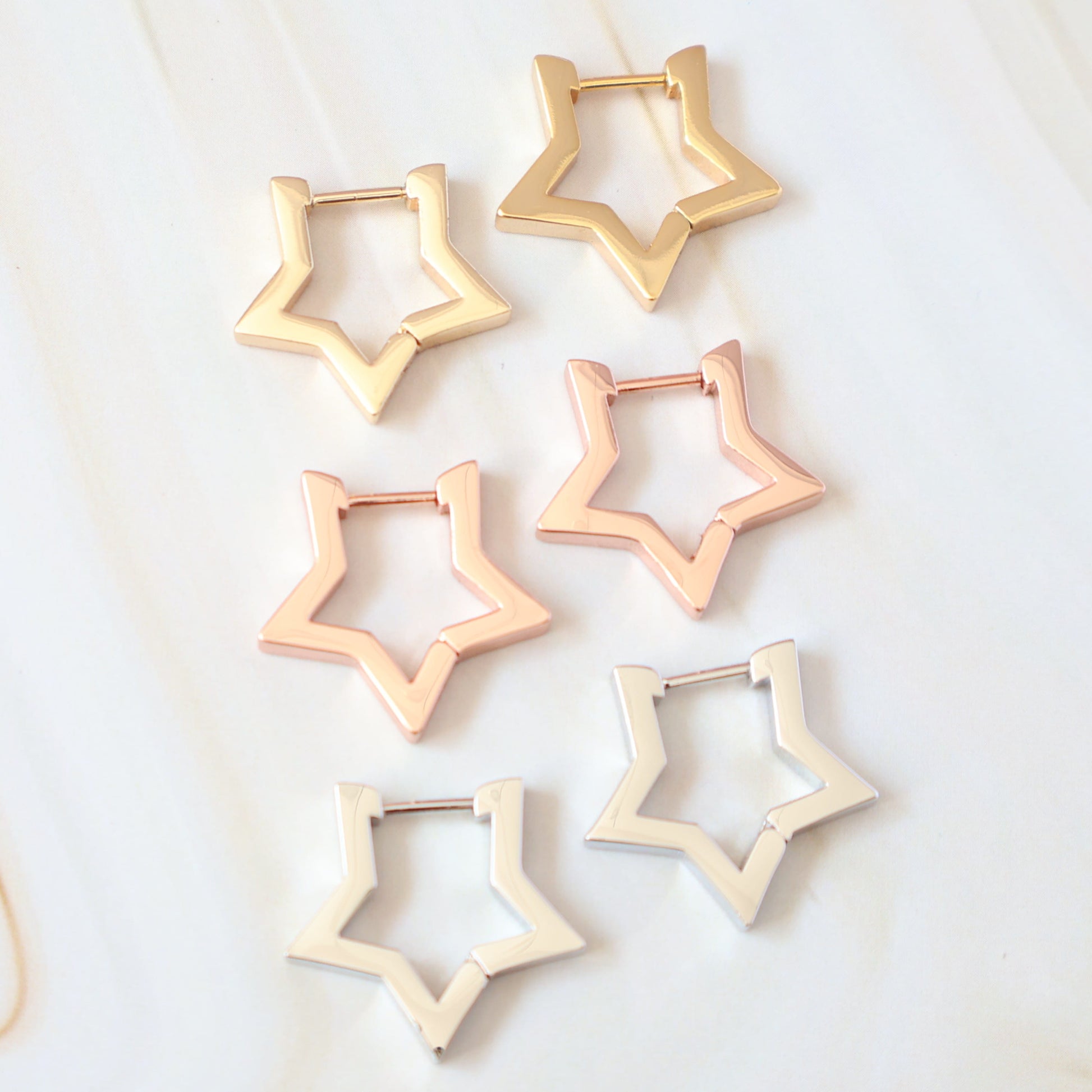 gold, rose gold and white gold star hoops